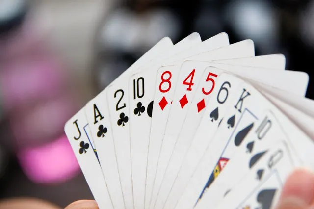 Hand holding playing cards-4530227761